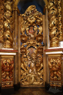 Vul. Khmelnytskoho, 36. The royal doors of the iconostasis with icons of Christ and Mary on their sides, and predellas below done by artist Modest Sosenko